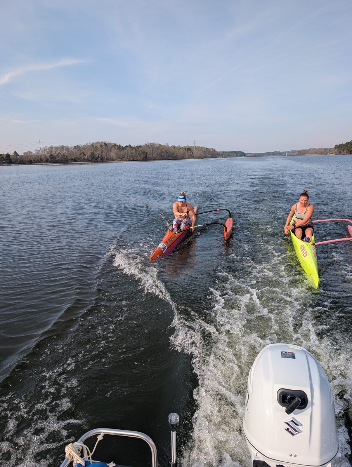 April and paddlers training in OC1 outrigger canoes on Hyco Lake.
